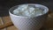 Rice in a porcelain bowl, with Japanese chopsticks, soy sauce, served on a gray stone table Close up