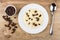 Rice porridge with milk, raisins, bowl with raisin, spoon