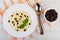 Rice porridge with raisin in plate, dried grape, spoon