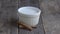 Rice pudding in a white bowl on a wooden base. Process of putting the sugar for burning.