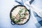 Rice risotto with mushrooms, parmesan and spinach top view on blue wooden background