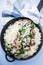 Rice risotto with mushrooms, parmesan and spinach top view on blue wooden background