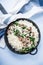 Rice risotto with mushrooms, parmesan and spinach top view on blue wooden background