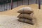 Rice in a sack that is in a warehouse for storing rice. Canvas bags stacked in a pile