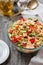 Rice salad with salmon, cucumbers, peas and bell pepper,