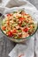 Rice salad with salmon, cucumbers, peas and bell pepper,