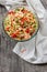 Rice salad with salmon, cucumbers, peas and bell pepper,