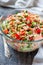 Rice salad with salmon, cucumbers, peas and bell pepper,
