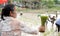 Rice seedlings in the hands of an elderly woman with a blur of the muddy Asian children enjoys planting rice in the field farm