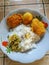 rice with a side dish of boiled chicken eggs, a little vegetables and cakes
