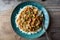 Rice smothered with homemade crawfish etouffee. Shown with whole boiled crawfish and green onions on a wood background.