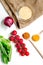 Rice, spices and vegetables for paella on white desk background top view