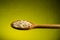 Rice in a spoon, close up, color background