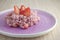 Rice with strawberries on purple plate