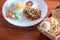 Rice topped fried egg with stir-fried pork and basil and bread