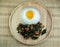 Rice topped spicy fried pork with basil leaves topping Fried Eggs on wooden dish