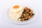 Rice topped with stir-fried chicken, basil and fried egg, fried stir basil with minced chicken on white background