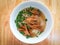 Rice vermicelli noodle soup stewed chicken feet bowl on wooden table background