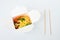 Rice wok in box and bamboo chopsticks isolated on white background, takeout and takeaway concept