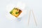 Rice wok in box and bamboo chopsticks isolated on white background, takeout and takeaway concept