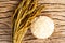 Rice in wooden bowl with paddy rice on rustic wood background,Rice of famer in Thailand