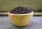 Riceberry in wooden bowl rustic wood background.