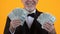 Rich aged gentleman in suit showing dollars, lottery winner, business income