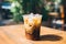 A rich, aromatic, and frothy iced coffee, in the relaxing ambiance of a cozy urban cafe patio