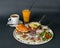 Rich breakfast - corn porridge, croissant with sliced chicken, rucola, tomato and cheese salad with pesto sauce, boiled chicken