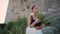 Rich businesswoman going street with tropical greenery close up. Woman walking