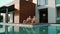 Rich couple relaxing near swimming pool atprivate house.