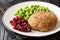 Rich and delicious Swedish veal patties Wallenbergare with boiled green peas closeup in the plate. Horizontal