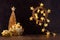 Rich  home interior - golden decoration for christmas - christmas tree, glowing lights, stars, wreath, balls, gift box, ribbons.