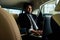 Rich indian businessman in formal wear drive car