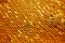 Rich luxurious golden macro texture of yellow metallic gold scale sequin beads. Christmas  New Year festive holiday shiny