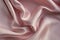 Rich powdery pink satin folded fabric background