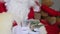 Rich santa claus with white beard counts paper banknotes, money, christmas concept, waiting for gifts, new year celebration,