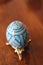 Richly Decorated Blue Pysanky Ukrainian Easter Egg on a Gold Stand