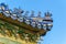 Richly decorated roofs of a Chinese temple, small colorful details with figurines