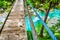 Rickety bridge handrail footbridge river background wooden boards