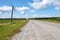 Rickety electric poles standing along the road