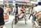 Rickshaw on cycle driving on busy streets with rushing vehicles, bicycles in indian city traffic jam