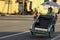 A rickshaw driver pushing a wheeled cart on the streets of the heritage city of