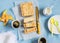 Ricotta orange tart and coffee on a blue background, top view.