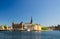 Riddarholmen island district with Riddarholm Church spires and typical sweden colorful gothic buildings, boat ship moored on Lake