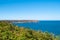 Ride on the GR34 in Brittany with far off Cape Frehel and its lighthouse