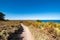 Ride on the GR34 in Brittany with far off Cape Frehel and its lighthouse