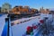 Ridea canal covered in snow, with NAC ad parliament hill in the background, Ottawa