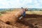 Rider on a cross-country motorcycle in sports equipment turns on a sharp turn at high speed