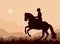 A rider gallops in a field, a dark silhouette against the sky,